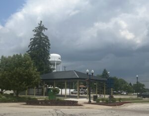 Water tower and park pavilion under stormy sky